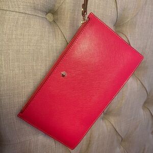 Pink Kate Spade Roulette Wristlet with gold hardware